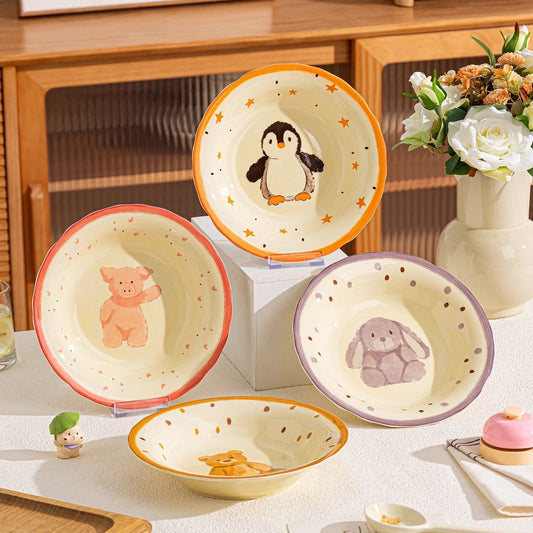 Set of ceramic bowls with animal illustrations on a table.